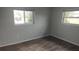 Empty bedroom featuring hard flooring and natural light from two windows at 1001 Sandlewood Dr, Venice, FL 34293