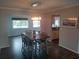 Elegant dining room featuring stylish light fixture, hardwood floors, and a wood dining table at 1001 Sandlewood Dr, Venice, FL 34293