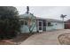 Exterior view of house with driveway and a screened patio at 1001 Sandlewood Dr, Venice, FL 34293