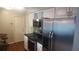 Modern kitchen with stainless steel appliances, white cabinetry, and dark countertops at 1001 Sandlewood Dr, Venice, FL 34293