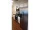 Modern kitchen with stainless steel appliances, white cabinetry, and dark countertops at 1001 Sandlewood Dr, Venice, FL 34293