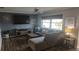 Comfortable living room with a large sectional sofa, stylish decor, and hardwood floors at 1001 Sandlewood Dr, Venice, FL 34293