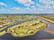 Scenic aerial view showcasing the neighborhood's golf course and multiple water features at 10808 Tarflower Dr # 102, Venice, FL 34293