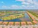 Wide aerial shot of a residential area with water features and green spaces at 10808 Tarflower Dr # 102, Venice, FL 34293