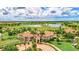 Aerial view of the golf course community with lush landscaping, water features, and beautiful clubhouse at 10808 Tarflower Dr # 102, Venice, FL 34293