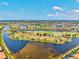 Panoramic aerial view of a community with multiple lakes and a golf course at 10808 Tarflower Dr # 102, Venice, FL 34293
