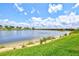 The backyard offers a scenic view of the lake and landscaped grounds at 10808 Tarflower Dr # 102, Venice, FL 34293