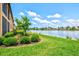 Well maintained backyard landscaping offers serene water views, and manicured green spaces at 10808 Tarflower Dr # 102, Venice, FL 34293