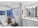 Bright bathroom featuring a vanity with a white countertop, patterned shower curtain, and neutral walls at 10808 Tarflower Dr # 102, Venice, FL 34293