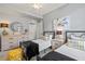Bedroom featuring two twin beds, gray walls, ceiling fan, and modern decor at 10808 Tarflower Dr # 102, Venice, FL 34293