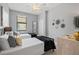 Bedroom featuring two twin beds, window, ceiling fan, light gray walls and modern decor at 10808 Tarflower Dr # 102, Venice, FL 34293