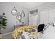 Bedroom with accent wall decor, a ceiling fan, and a view out of the window at 10808 Tarflower Dr # 102, Venice, FL 34293
