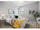 A bedroom features a large window, ceiling fan, and a beautifully made bed at 10808 Tarflower Dr # 102, Venice, FL 34293
