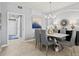 Open-concept dining room with contemporary light fixture and neutral color palette at 10808 Tarflower Dr # 102, Venice, FL 34293