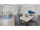 Dining room with modern chandelier and a view of the decorative front door at 10808 Tarflower Dr # 102, Venice, FL 34293