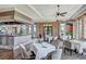Elegant dining room with a full bar, tables with chairs, and large windows providing natural light at 10808 Tarflower Dr # 102, Venice, FL 34293