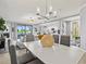 Dining room flows into living space with elegant furnishings and natural light at 10808 Tarflower Dr # 102, Venice, FL 34293