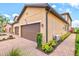 Exterior view of a townhome with two car garage, landscaping, and paver sidewalk at 10808 Tarflower Dr # 102, Venice, FL 34293