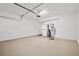 Spacious garage with epoxy flooring, refrigerator, and water heater at 10808 Tarflower Dr # 102, Venice, FL 34293