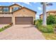 Townhome with a two-car garage and brick paver driveway in a well-maintained community at 10808 Tarflower Dr # 102, Venice, FL 34293