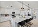 Spacious kitchen with white cabinets, stainless steel appliances, and a large center island at 10808 Tarflower Dr # 102, Venice, FL 34293