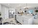 Open kitchen featuring a large island with stainless steel appliances and bright, modern decor at 10808 Tarflower Dr # 102, Venice, FL 34293