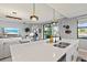 Modern kitchen with white countertops and stainless steel sink overlooking the living area at 10808 Tarflower Dr # 102, Venice, FL 34293
