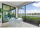 Screened-in lanai with seating and a view of the lake at 10808 Tarflower Dr # 102, Venice, FL 34293