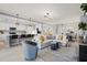Open-concept living area featuring stylish furniture, modern lighting, and view to the kitchen at 10808 Tarflower Dr # 102, Venice, FL 34293