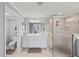 Bright main bathroom with glass walk-in shower, tile floors, and double-sink vanity at 10808 Tarflower Dr # 102, Venice, FL 34293