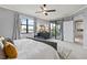 This main bedroom has a view of the lake from the sliding glass doors to the lanai at 10808 Tarflower Dr # 102, Venice, FL 34293