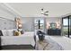 A beautifully staged main bedroom with gray walls, a large window and luxury bedding at 10808 Tarflower Dr # 102, Venice, FL 34293