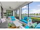 Screened in patio with stylish furniture offers beautiful views of the lake and landscaped grounds at 10808 Tarflower Dr # 102, Venice, FL 34293