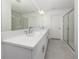 Bathroom featuring a long vanity with double sinks, a large mirror, and tiled floors and a shower at 11228 Fieldstone Dr, Palmetto, FL 34221