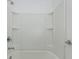 Bright bathroom with a shower/tub combo and a modern white surround, showcasing functionality at 11228 Fieldstone Dr, Palmetto, FL 34221