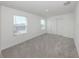 Carpeted bedroom with a closet and two windows offering natural light and a view of the neighborhood at 11228 Fieldstone Dr, Palmetto, FL 34221
