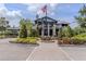 Exterior shot of the clubhouse featuring manicured landscaping and outdoor gathering spaces at 11228 Fieldstone Dr, Palmetto, FL 34221