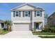 Charming two-story home featuring blue shutters, manicured lawn, and an attached two car garage at 11228 Fieldstone Dr, Palmetto, FL 34221