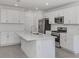 Modern kitchen with stainless steel appliances and white cabinetry at 11228 Fieldstone Dr, Palmetto, FL 34221