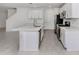 Modern kitchen with stainless steel appliances, white cabinets, a kitchen island, and an open floor plan at 11228 Fieldstone Dr, Palmetto, FL 34221