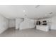 Bright, open-concept living area features white cabinets, stainless steel appliances, tile flooring, and natural light at 11228 Fieldstone Dr, Palmetto, FL 34221