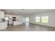Bright, open-concept living area features white cabinets, stainless steel appliances, tile flooring, and natural light at 11228 Fieldstone Dr, Palmetto, FL 34221