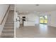 Open floor plan showcasing the kitchen and living area with sliding glass doors at 11228 Fieldstone Dr, Palmetto, FL 34221