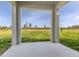 Covered patio with view of open land with lush grass, offering a tranquil outdoor space at 11228 Fieldstone Dr, Palmetto, FL 34221