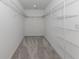 Spacious walk-in closet with ample shelving and carpeted floor at 11228 Fieldstone Dr, Palmetto, FL 34221