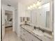 Bright bathroom featuring a large vanity, tile floors, and neutral decor at 1234 Paradise Way, Venice, FL 34285