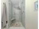 Modern bathroom with glass enclosed shower and unique stone tile flooring at 1234 Paradise Way, Venice, FL 34285