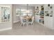 Cozy dining area features bright natural light, modern furnishings, and custom built-in storage at 1234 Paradise Way, Venice, FL 34285