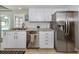 Charming kitchen featuring stainless steel appliances, granite countertops, and white cabinets at 1234 Paradise Way, Venice, FL 34285