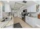 Well-lit kitchen featuring stainless steel appliances, tile flooring, and beautiful granite countertops at 1234 Paradise Way, Venice, FL 34285